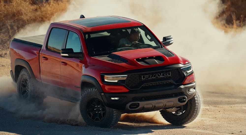 A red 2022 Ram 1500 TRX is shown off-roading.