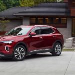 A family is shown walking towards a red 2022 Buick Envision they bought from a Buick dealership.