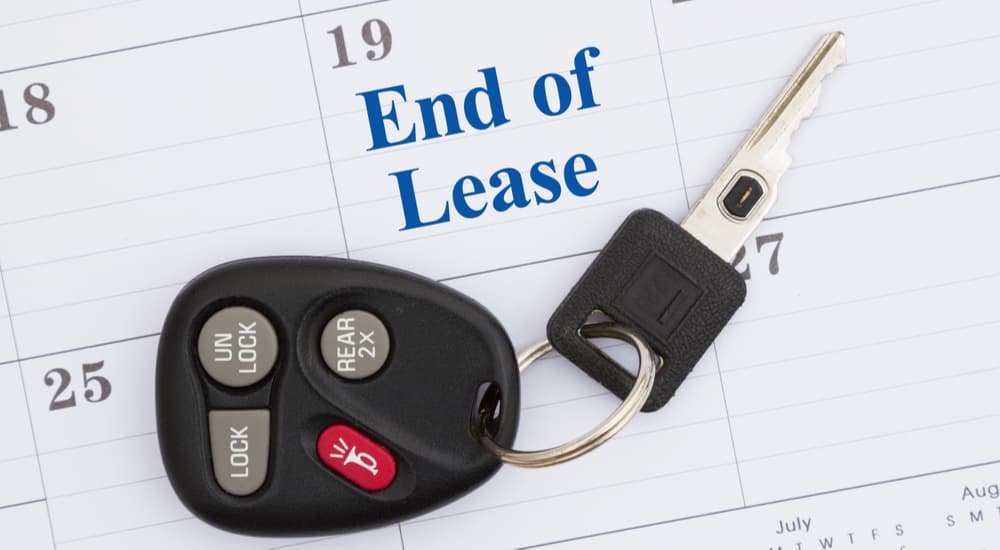 A car key is shown on a calendar marked 'end of lease.'
