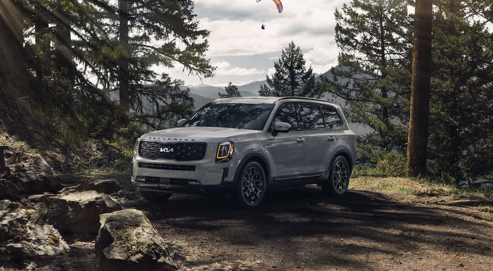 A grey 2022 Kia Telluride is shown parked on a mountain trail.