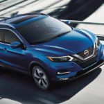 A blue 2021 Nissan Rogue Sport is shown leaving a Nissan Rogue dealer.