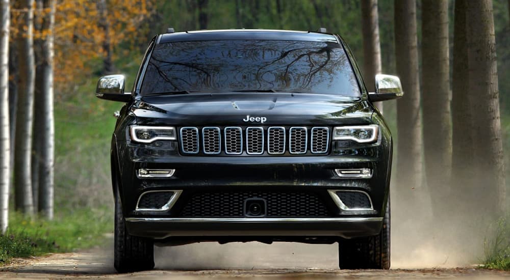 Popular at a used Jeep dealer, a black 2019 Jeep Grand Cherokee is shown from the front.