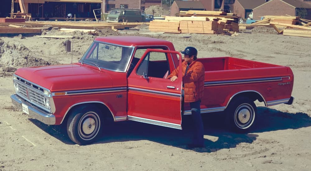 A man is shown getting into a red 1975 Ford F-150 Ranger.