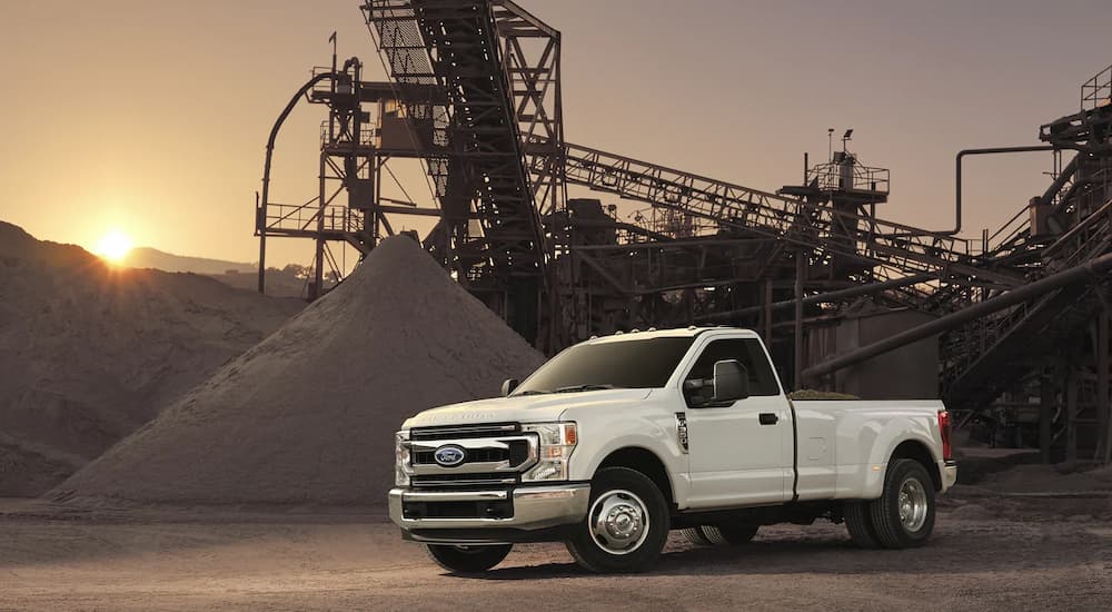 A white 2022 F-350 Super Duty is shown parked at a rock quarry.