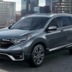 A grey 2022 Honda CR-V Touring is shown parked on a city building rooftop.