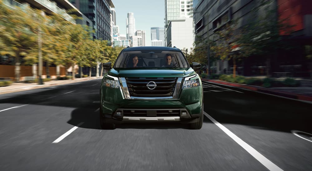 A green 2022 Nissan Pathfinder S is shown from the front during a 2022 Nissan Pathfinder vs 2022 Jeep Grand Cherokee L comparison.