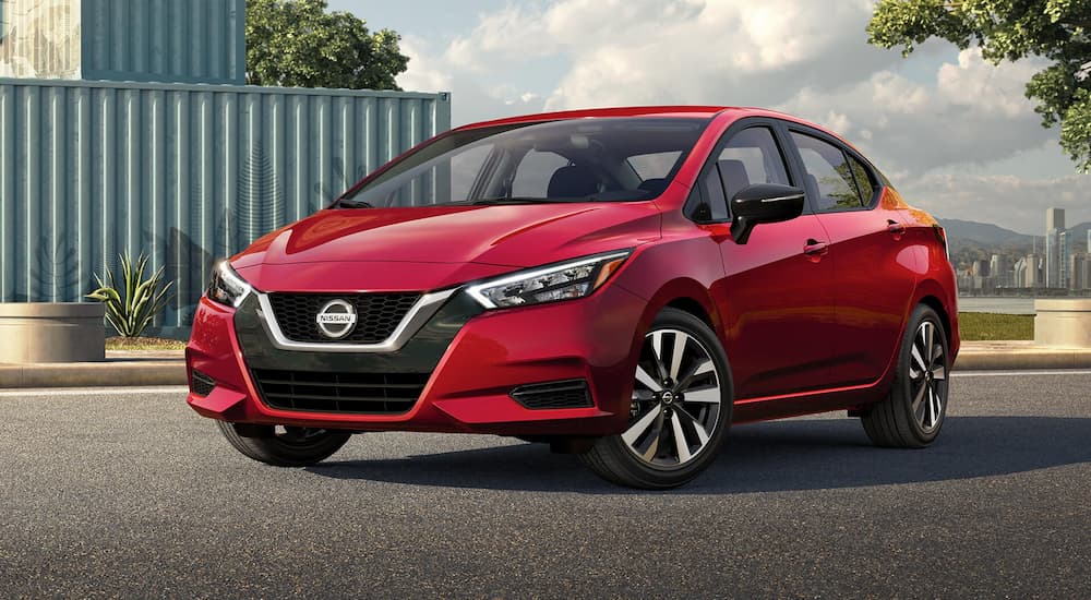 A red 2022 Nissan Versa SR is shown parked in an empty lot.