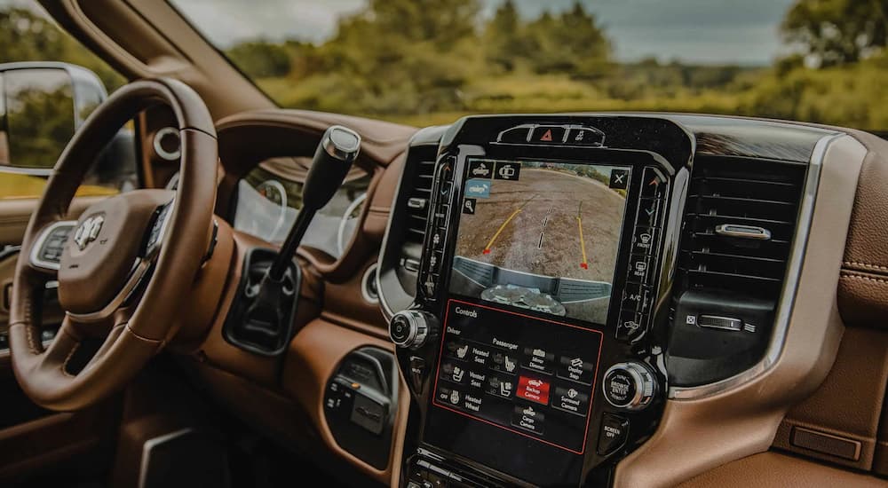 The brown interior shows the features of a 2022 Ram 2500 and 2022 Ram 3500.