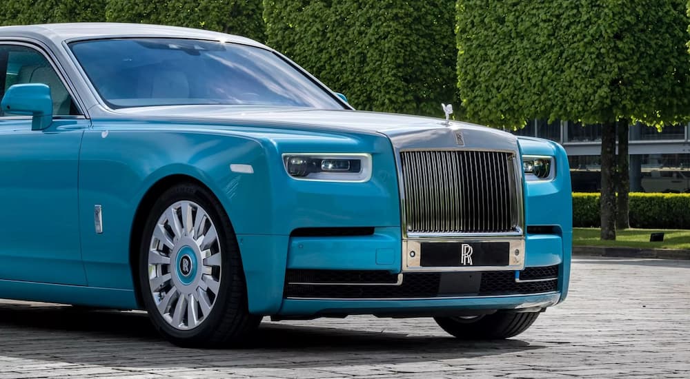 A blue 2022 Rolls-Royce Phantom is shown parked in a driveway.
