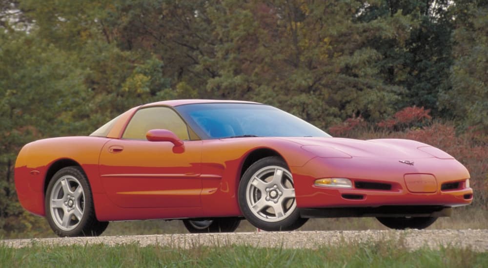 A red 2001 Chevy Corvette is shown parked after leaving a used Chevy dealer.