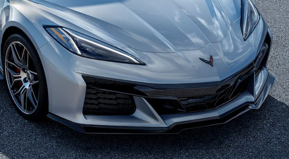 A close up shows the front of a silver 2023 Chevy Z06 parked on tarmac.