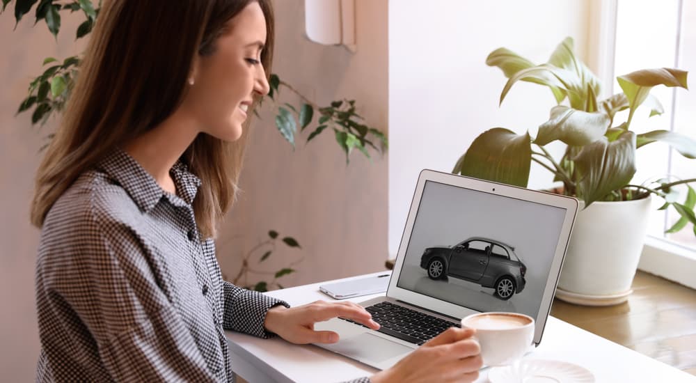 A woman is shown researching the Chevy pre-order process online.