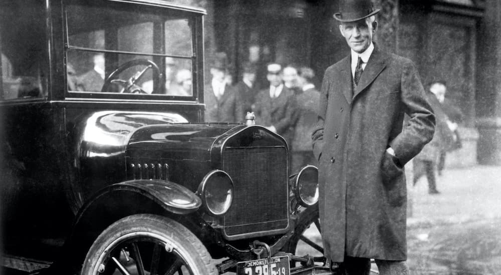 Henry Ford is shown next to a black 1921 Ford Model T.