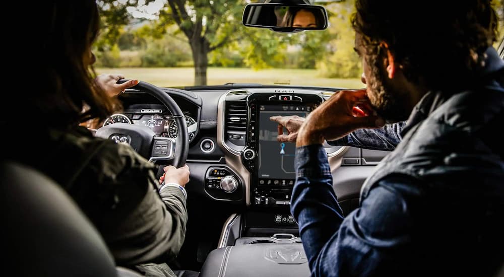 The interior of a 2022 Ram 2500 shows a couple driving home from a Ram 2500 dealership.