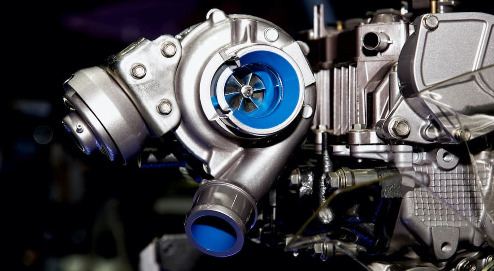A close up shows a turbocharger.