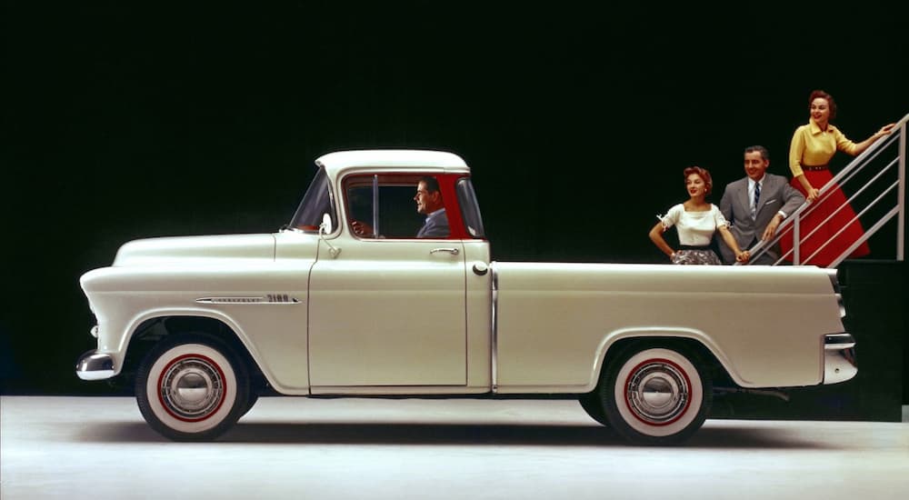 A white 1953 Chevy 3100 truck is shown during a used Chevy dealer advertisment.