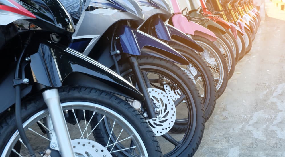 A row of motorcycles are shown at a used Honda dealer.