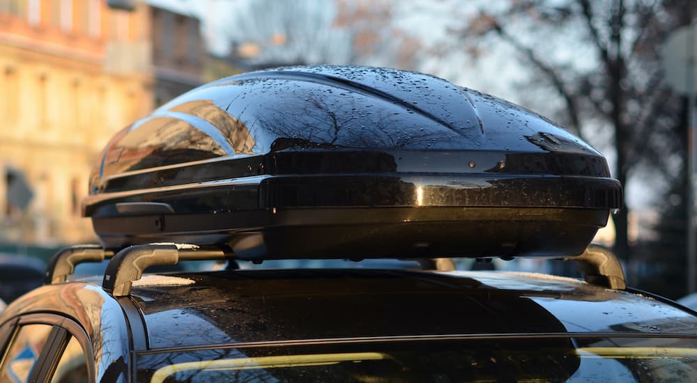 A close up shows a roof mounted cargo box.