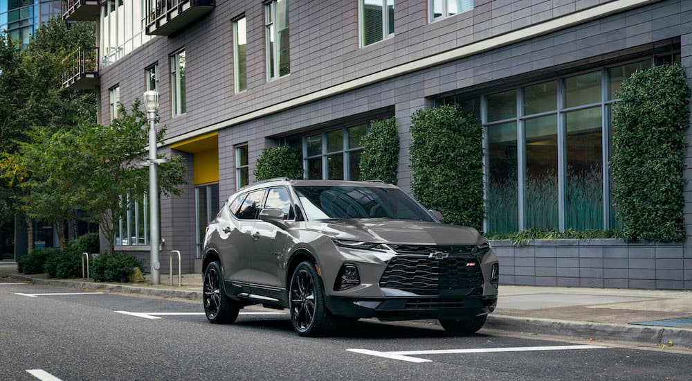 A grey 2022 Chevy Blazer RS is shown parked in a city.