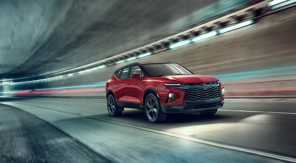 A red 2022 Chevy Blazer RS is shown driving through a tunnel.