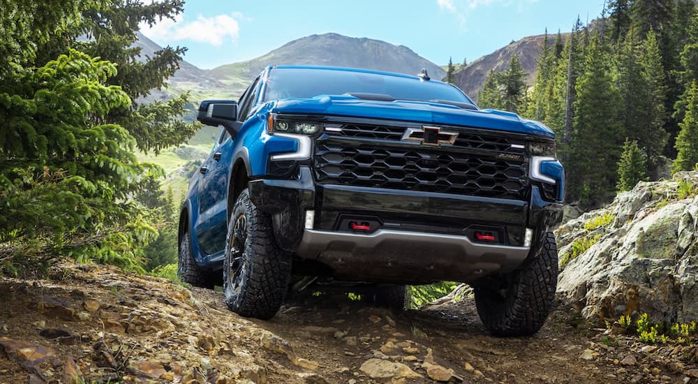 A blue 2022 Chevy Silverado 1500 ZR2 is shown from the front off-roading.