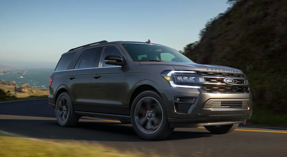 A grey 2022 Ford Expedition Stealth Performance Edition is shown driving during a 2022 Ford Expedition vs 2022 Toyota Sequoia competition.