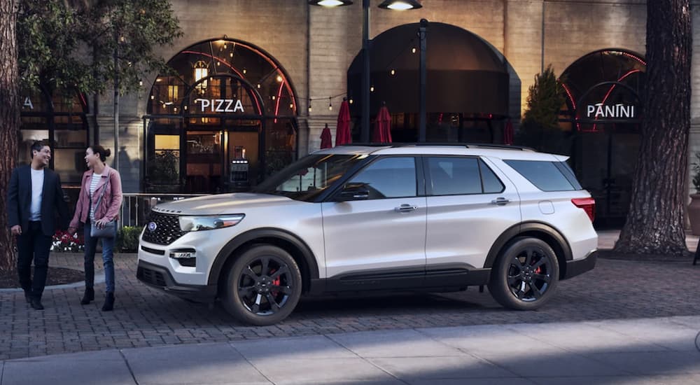 A white 2022 Ford Explorer ST is shown from the side parked in front of a store.