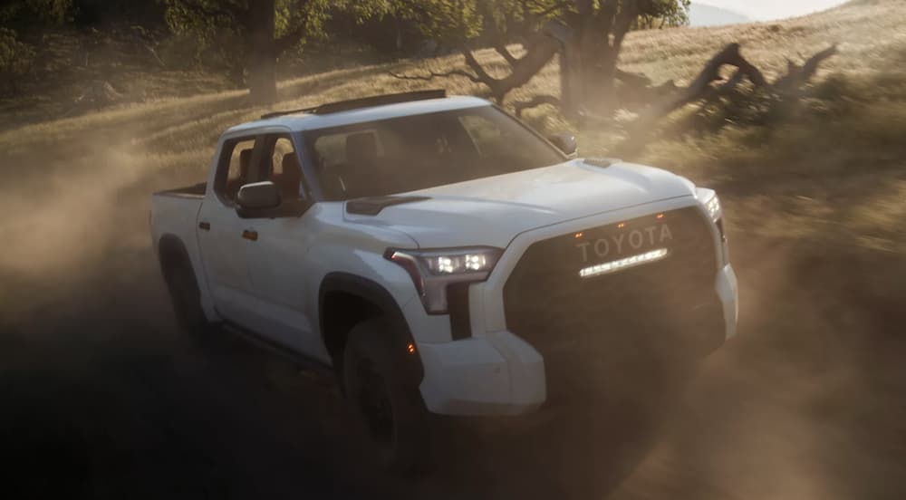 A white 2022 Toyota Tundra TRD is shown from the front off-roading.