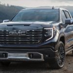A black 2022 GMC Sierra is shown from the front parked by a river after winning a 2022 GMC Sierra 1500 vs 2022 Toyota Tundra comparison.