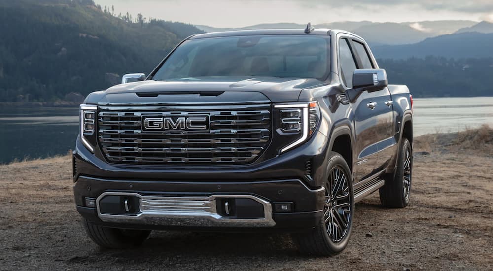 A black 2022 GMC Sierra is shown from the front parked by a river after winning a 2022 GMC Sierra 1500 vs 2022 Toyota Tundra comparison.