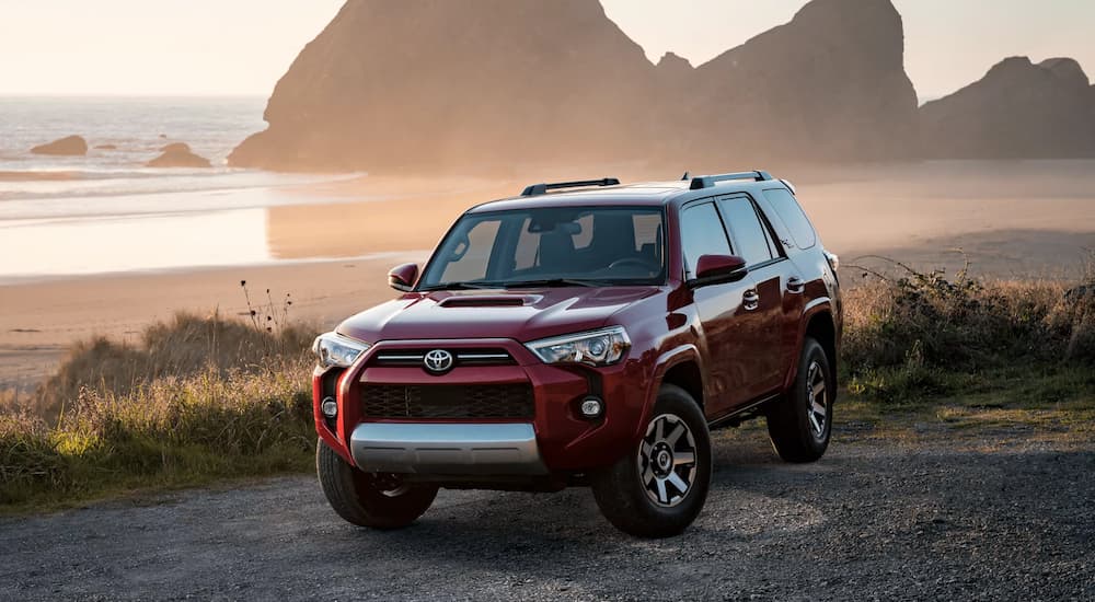 A red 2022 Toyota 4Runner TRD is shown parked near a body of water.