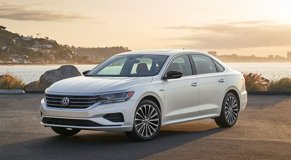 A white 2022 Volkswagen Passat Limited is shown overlooking an ocean.