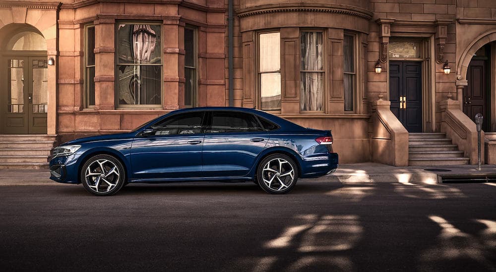 A blue 2022 Volkswagen Passat R-Line is shown parked on a city street.