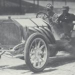 Louis Chevrolet is shown driving a race car in 1910.