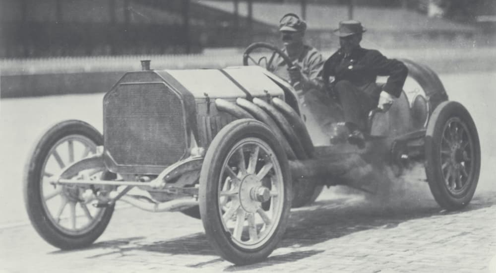 Louis Chevrolet is shown driving a race car in 1910.