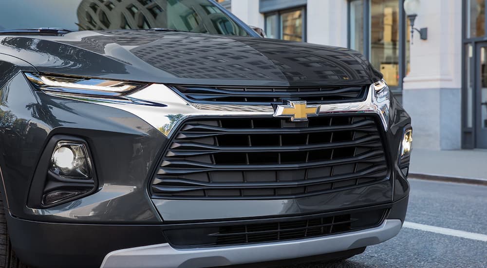 A close up of a black 2022 Chevy Blazer shows the front grille and headlights at a Chevy Blazer dealer.