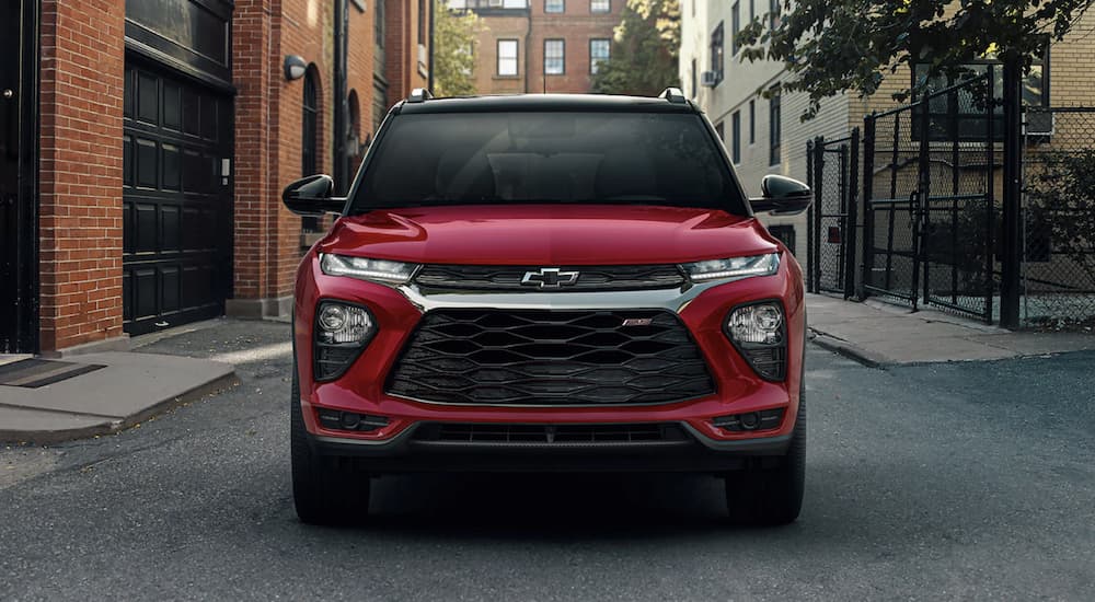 A red 2021 Chevy Trailblazer RS is shown from the front parked on a city street.