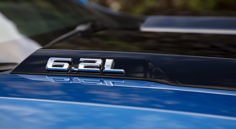 A blue 2022 Chevy Silverado 1500 ZR2 shows the 6.2L detail in close up.