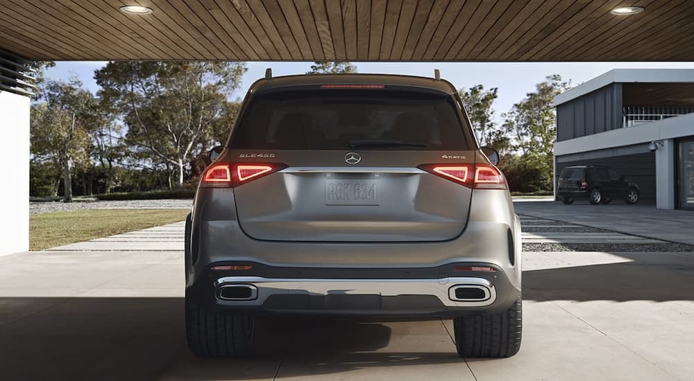 A popular pre-owned luxury SUV, a silver 2022 Mercedes-Benz GLE, is shown from the rear in a driveway.