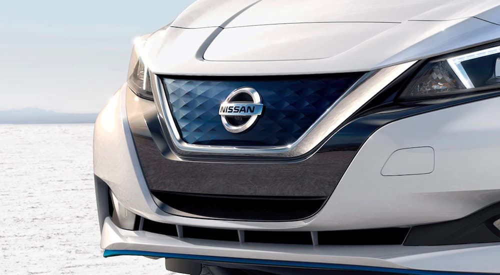 A close up shows the V-Motion grille on a white 2022 Nissan LEAF.