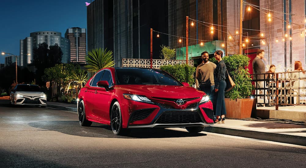 A red 2022 Toyota Camry XSE is shown parked outside of a restaurant.