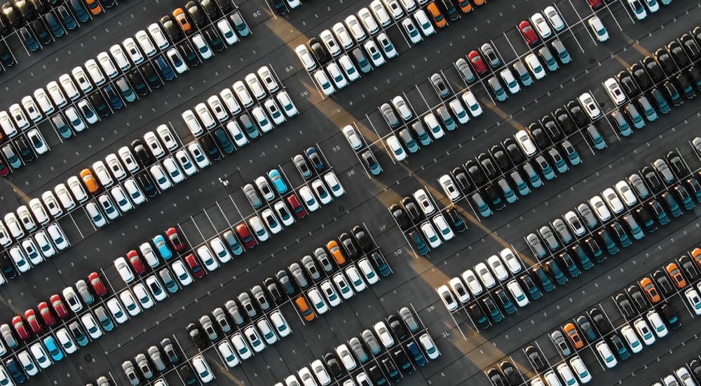 A parking lot of cars is shown from a high angle.