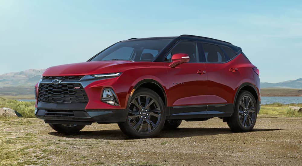 A red 2022 Chevy Blazer RS is shown from the side parked in a field.