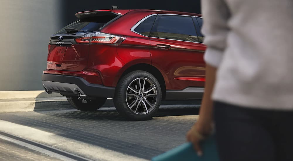 The rear end of a red 2022 Ford Edge Titanium is shown.