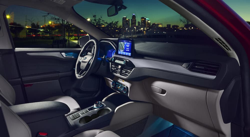 The black and grey interior of a 2022 Ford Escape is shown at night.