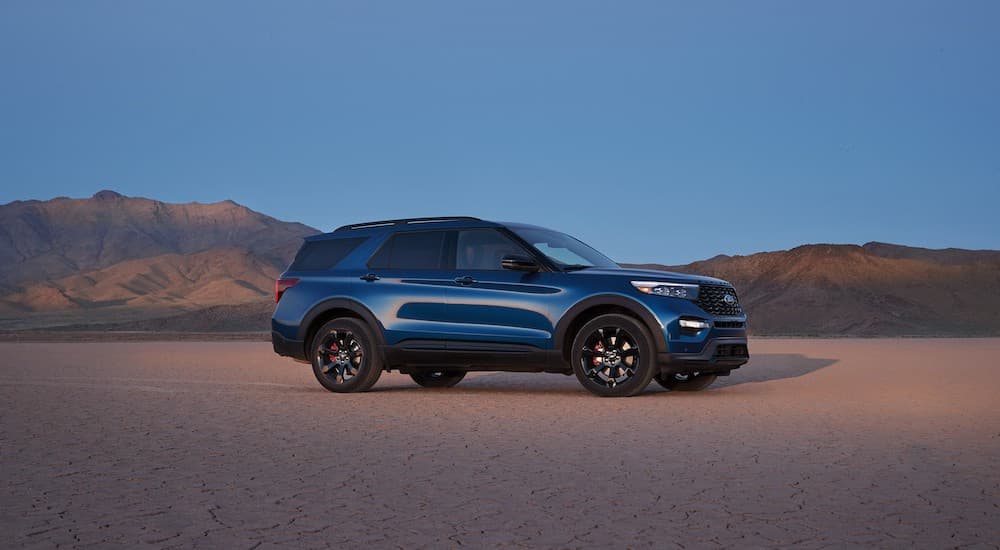 A blue 2022 Ford Explorer ST-Line is shown parked in the desert at dusk.