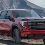 A red 2022 GMC Sierra 1500 is shown from the front parked in the mountains after winning a 2022 GMC Sierra 1500 vs 2022 Ram 1500 comparison.
