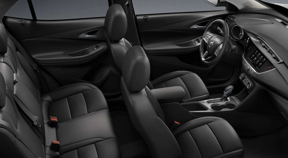 The black interior of a 2022 Buick Encore GX shows two rows of seating.