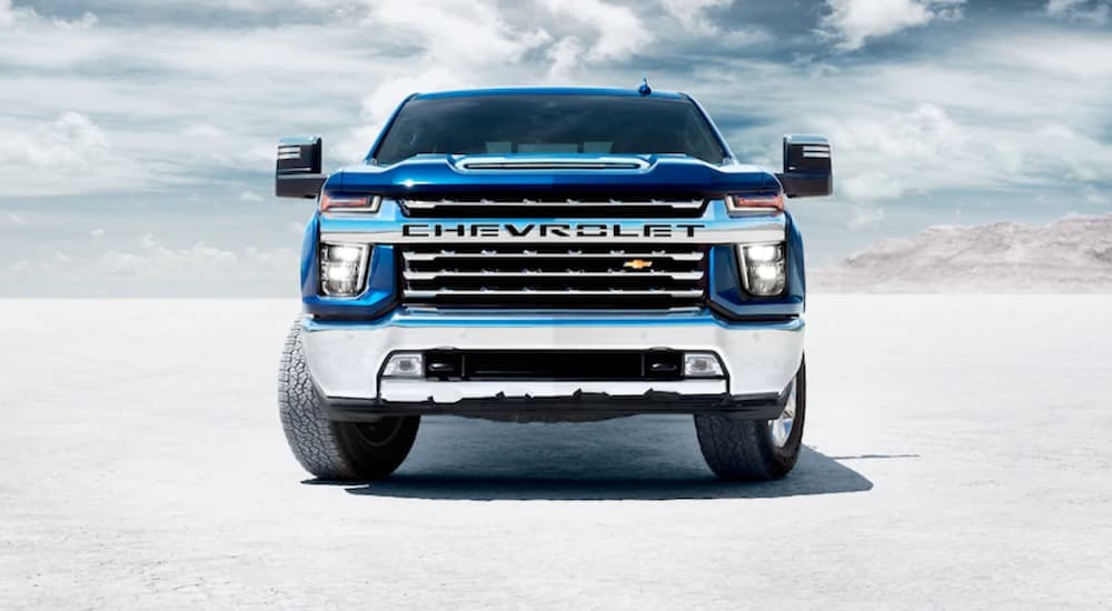 A blue 2020 Chevy Silverado 1500 HD is shown from the front parked on salt flats.