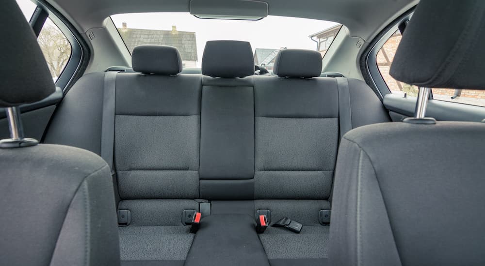 A grey interior of a car shows the back row of seats at a used Nissan dealer near you.